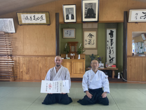 Omer Luskie präsentiert, in Japan mit Suganuma Sensei, seine Urkunde für den 5. Dan